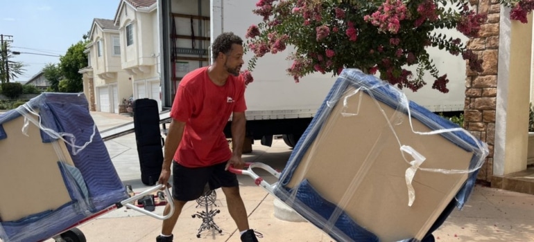 A mover moving two items, on a driveway