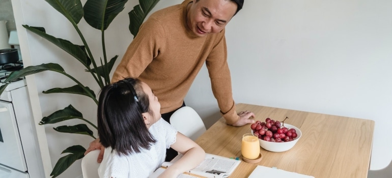 Picture of a man and a girl doing homework
